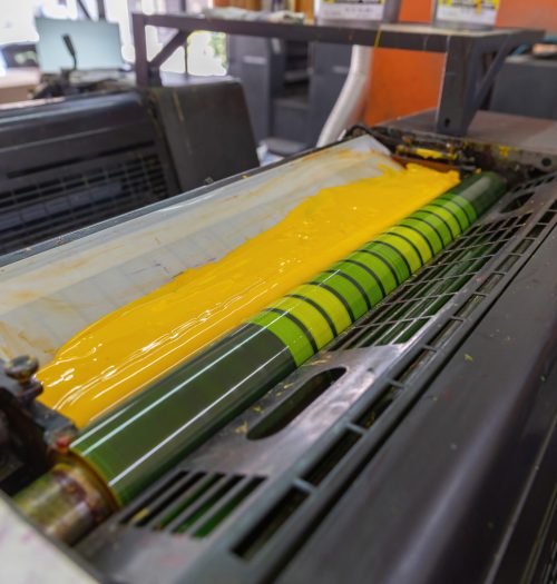 Offset printing machines. Large printing machine perspective. printing machine cylinders and printing ink pot. Offset machine. Offset press is a printing machine designed to produce fine quality