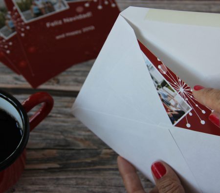 woman-putting-christmas-cards-in-envelopes-to-be-s-2025-01-16-11-16-27-utc